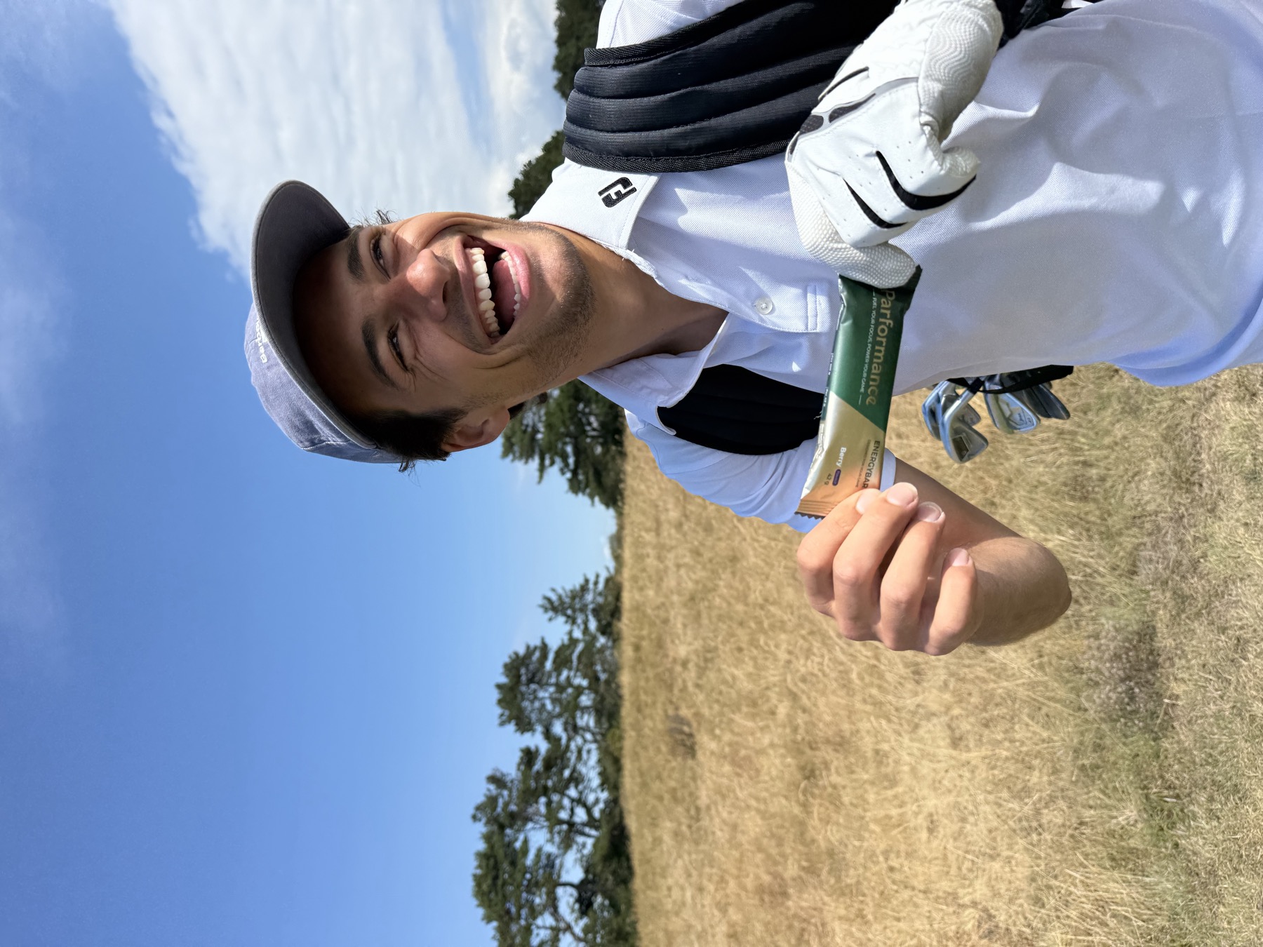 A golfer eating a Parformance Energy Bar on the fairway