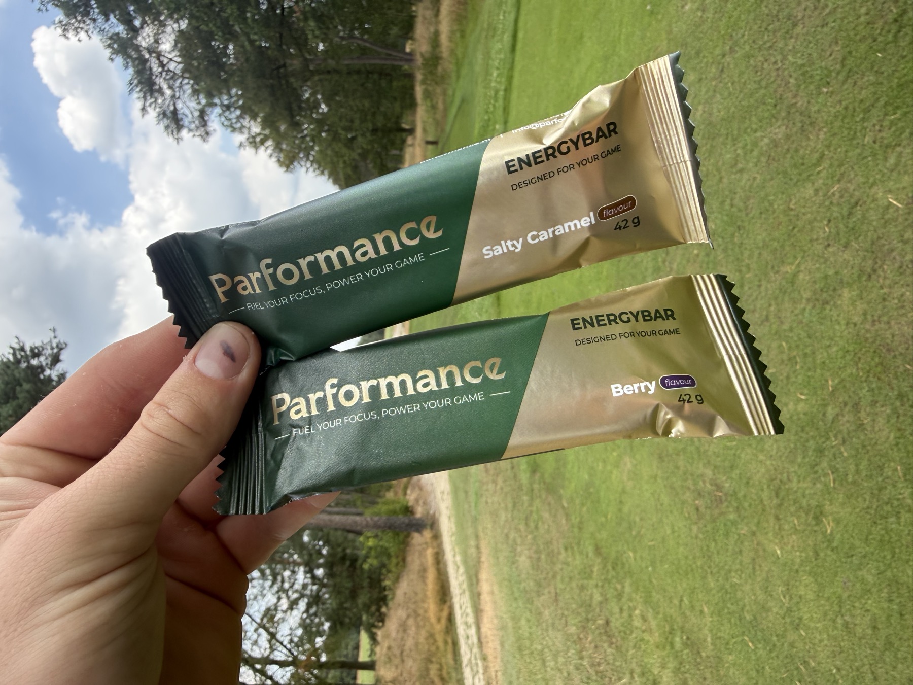 Unwrapping a Parformance Energy Bar by the golf bag